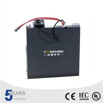 Dark lithium ion forklift battery pack with red and black cables, angled front view